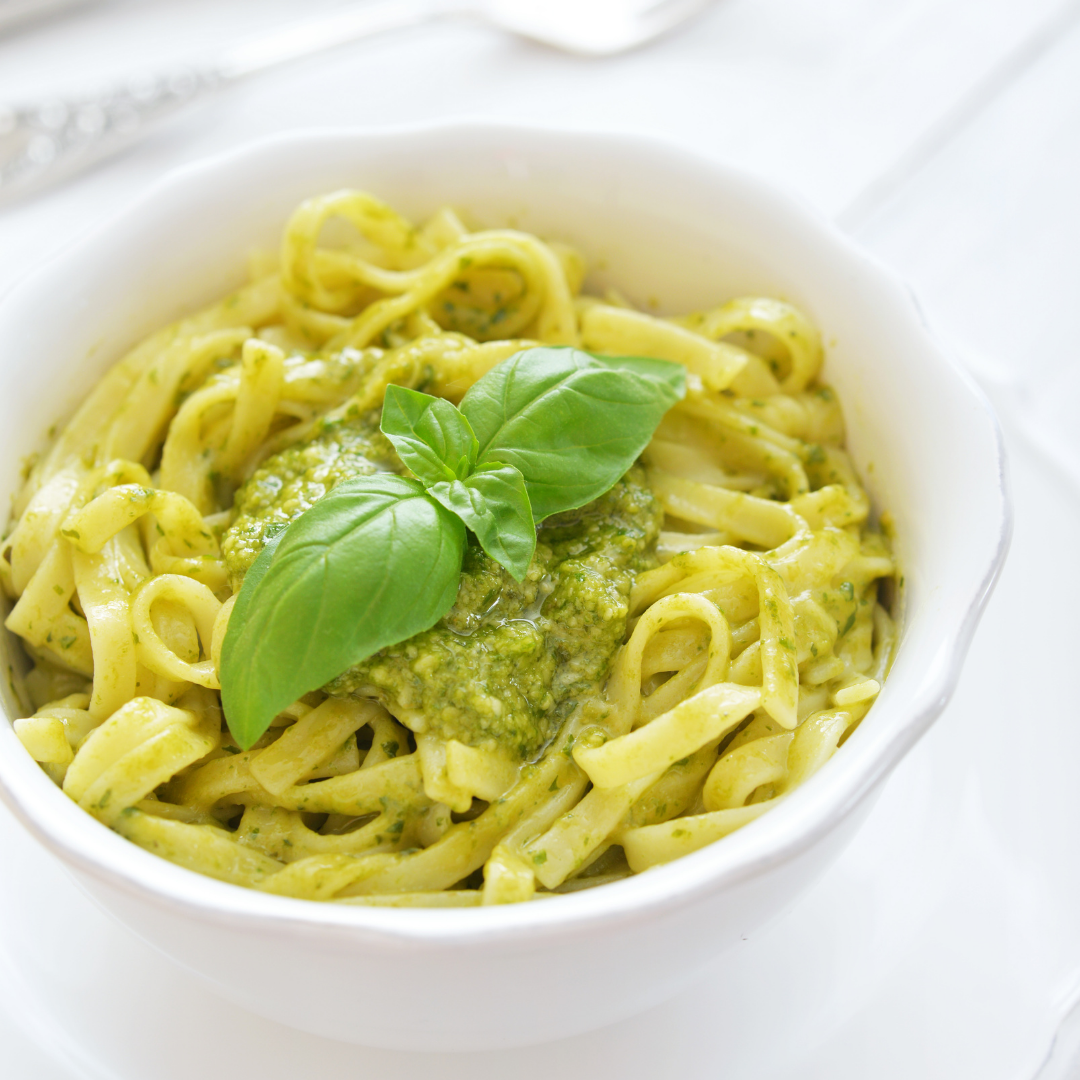 trenette with pesto pasta in bowl with basil garnish